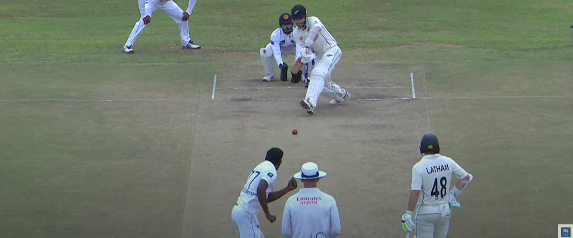 Prabath Jayasuriya celebrates after dismissing Kane Williamson during a Test match, showcasing his exceptional spin bowling skills.